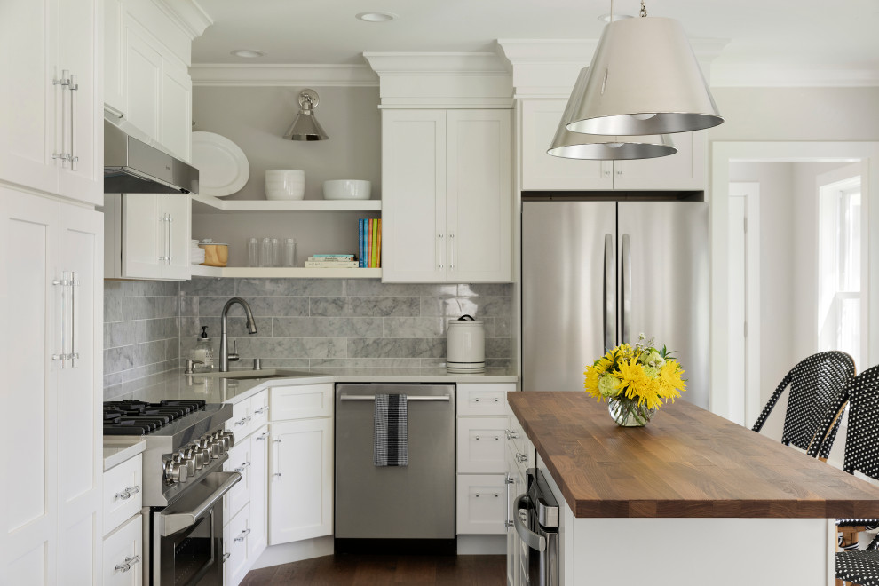 Eat-in kitchen - mid-sized transitional l-shaped dark wood floor and brown floor eat-in kitchen idea in Minneapolis with an undermount sink, shaker cabinets, white cabinets, quartz countertops, gray backsplash, marble backsplash, stainless steel appliances, an island and white countertops