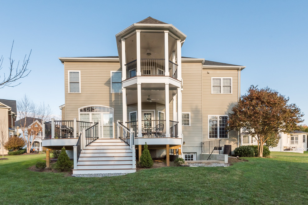 Large transitional backyard deck photo with decking and a roof extension
