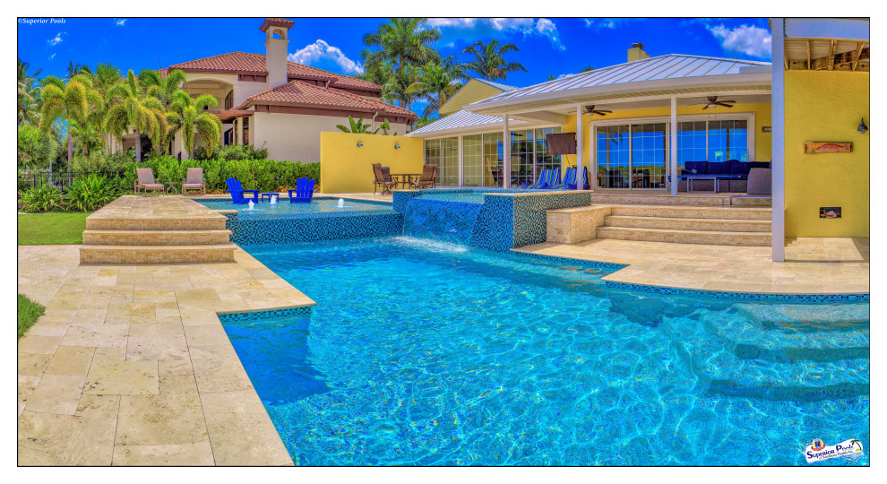 Inspiration for an expansive modern courtyard custom-shaped lap pool in Tampa with a pool house and natural stone pavers.