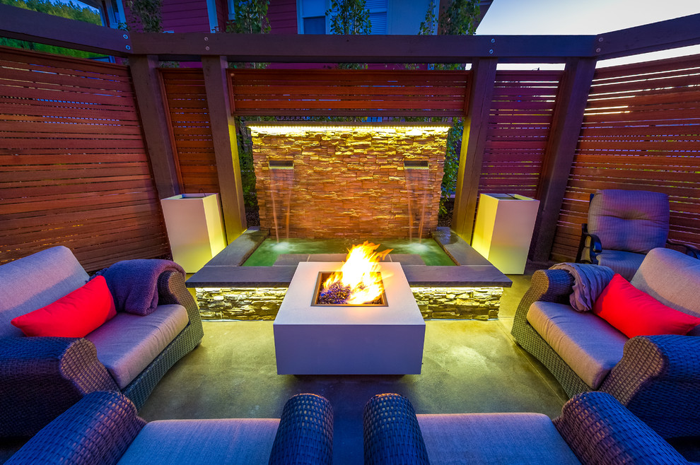 Photo of a mid-sized traditional backyard patio in Calgary with a fire feature.