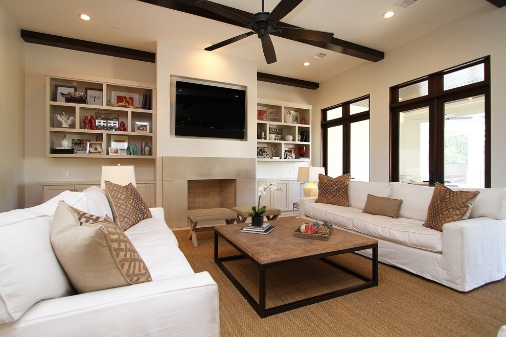Large transitional open concept family room in Houston with a standard fireplace, a stone fireplace surround, a wall-mounted tv, beige walls, ceramic floors and beige floor.