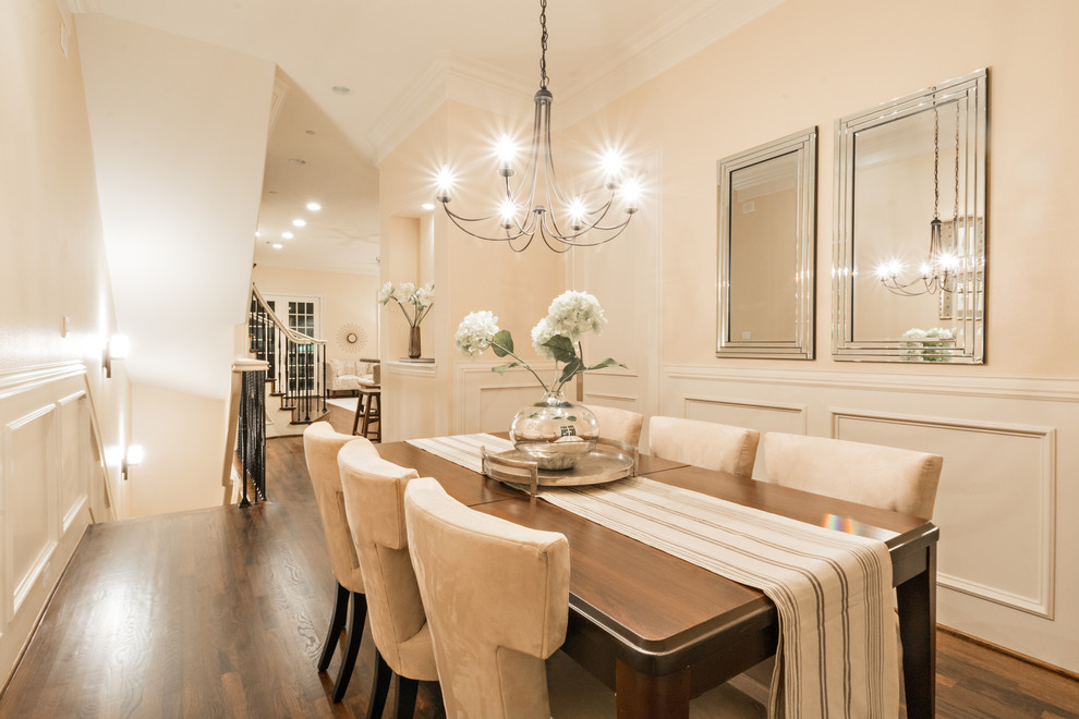 Photo of a transitional dining room in Dallas with beige walls and medium hardwood floors.