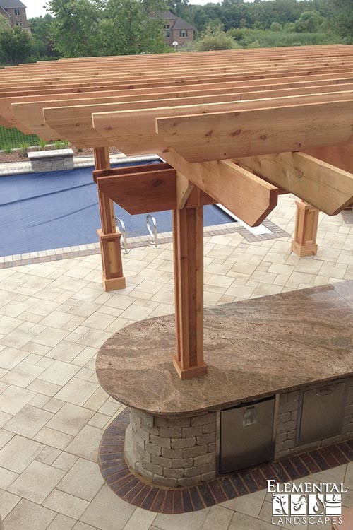 Patio kitchen - huge transitional backyard concrete paver patio kitchen idea in Chicago with a pergola