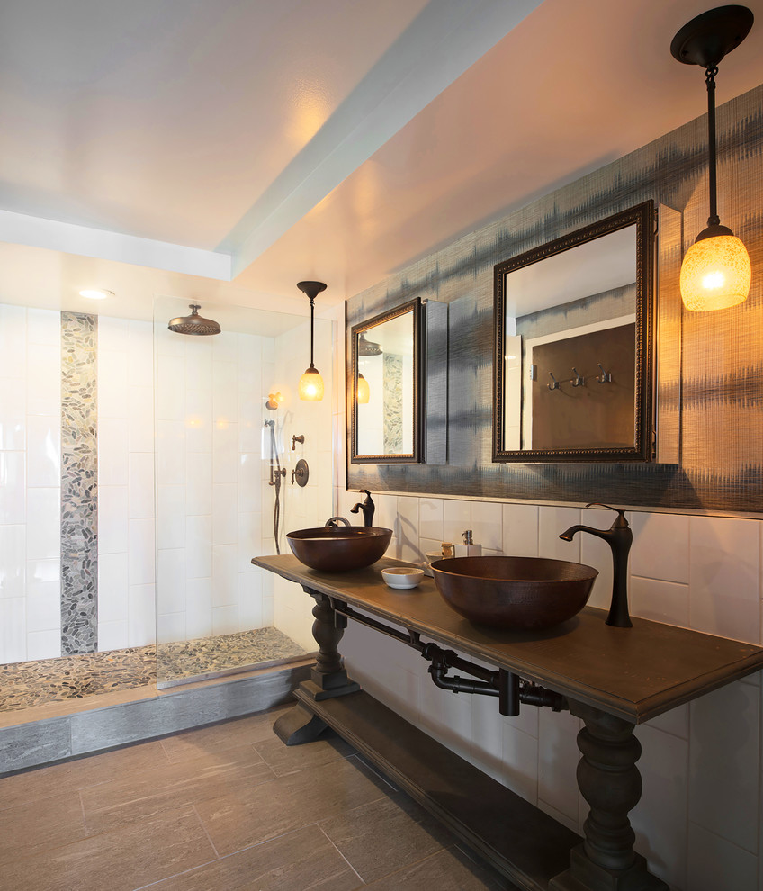 Inspiration for a large mediterranean master bathroom in Los Angeles with dark wood cabinets, an alcove shower, white tile, ceramic tile, multi-coloured walls, dark hardwood floors, a vessel sink, wood benchtops, brown floor, a hinged shower door and brown benchtops.