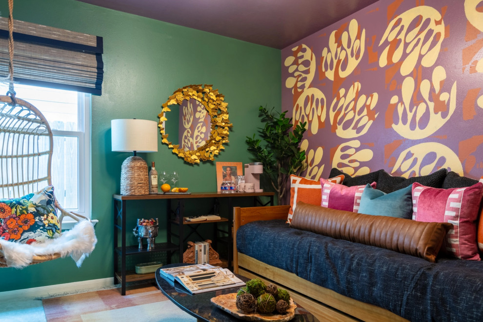 This is an example of a small tropical guest bedroom in Houston with green walls, carpet and beige floor.