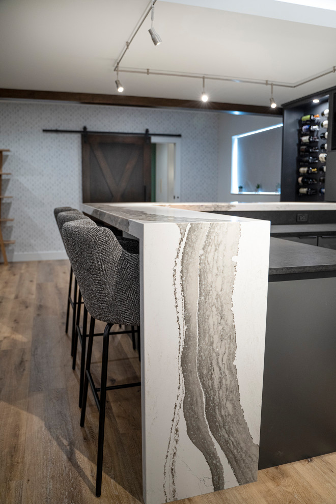 Example of a large minimalist look-out vinyl floor and wallpaper basement design in Other with a bar and black walls