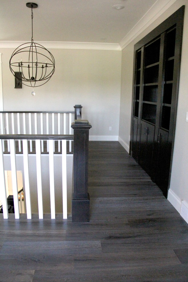 Hallway - large medium tone wood floor and brown floor hallway idea with beige walls