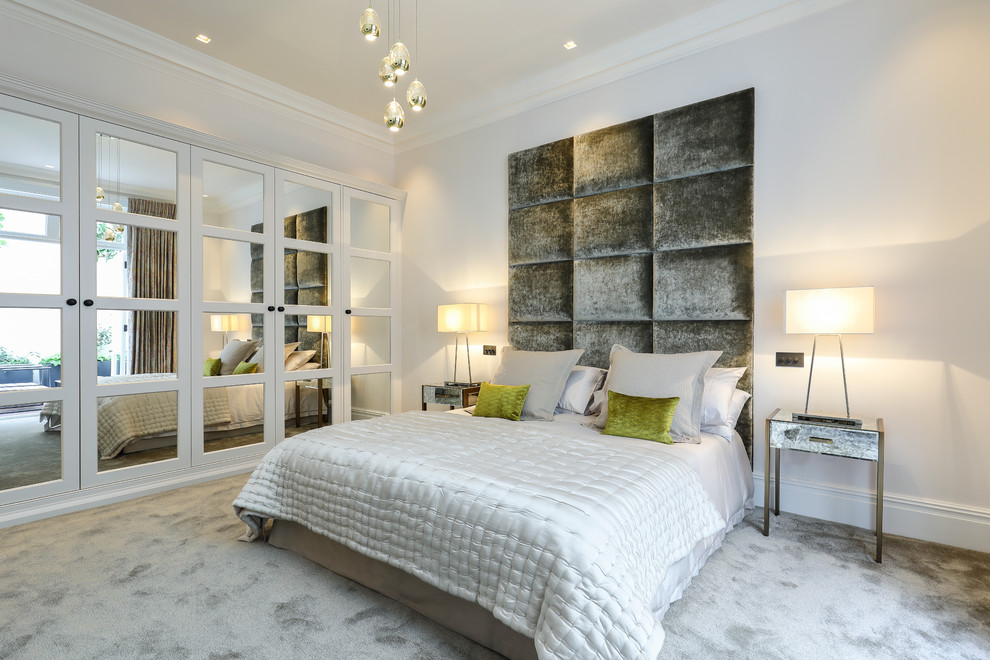 Design ideas for a transitional master bedroom in London with grey walls and carpet.