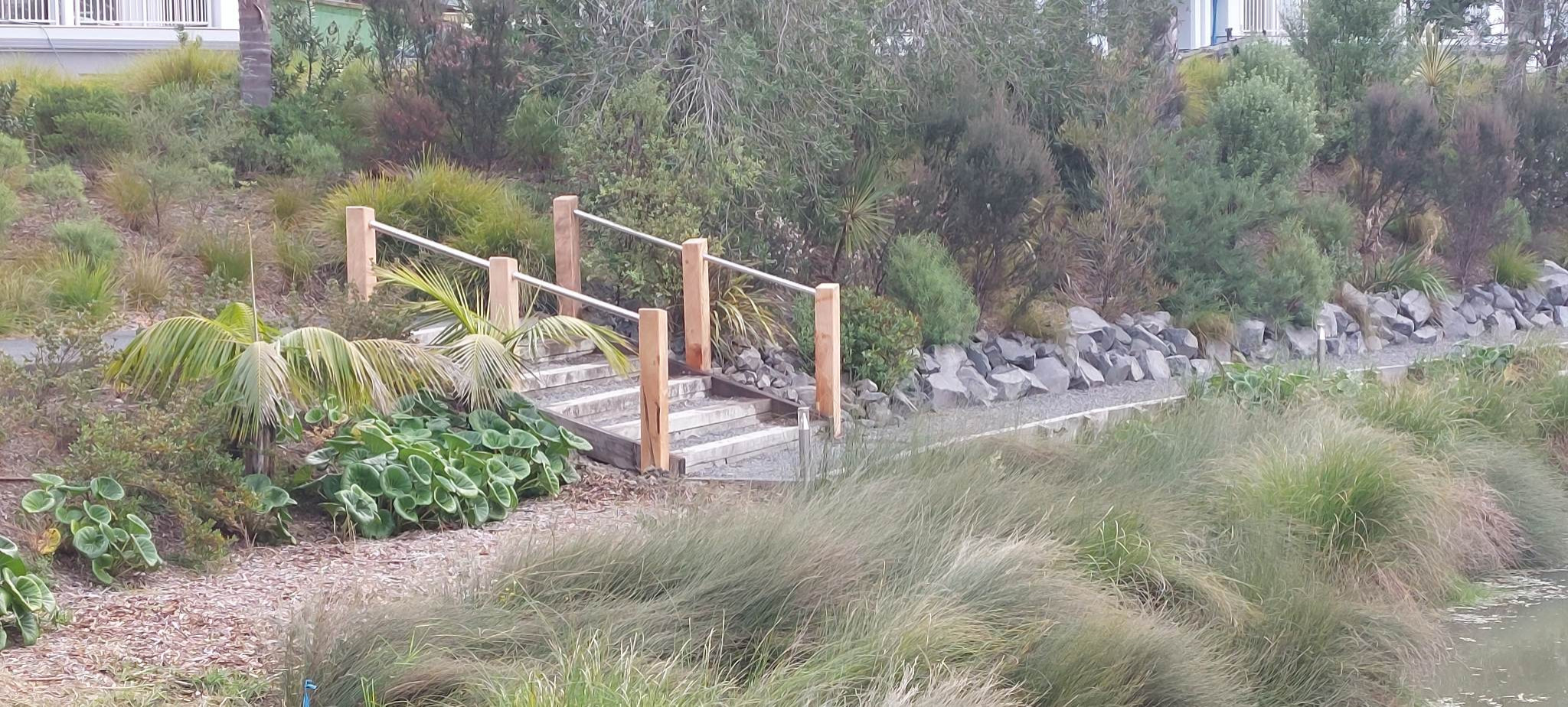Handrails and stairs that lead to the newly reinstated garden path.