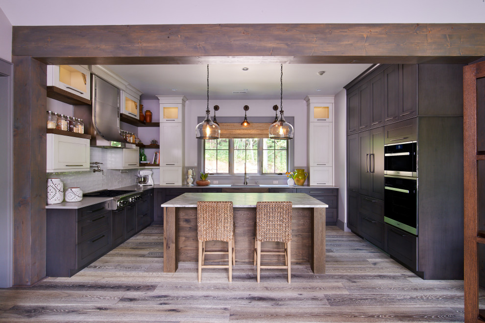 Large minimalist u-shaped light wood floor and beige floor open concept kitchen photo with an undermount sink, recessed-panel cabinets, dark wood cabinets, granite countertops, beige backsplash, quartz backsplash, stainless steel appliances, an island and gray countertops