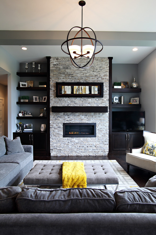 Transitional formal living room in Cedar Rapids with grey walls, dark hardwood floors, a ribbon fireplace, a stone fireplace surround and a freestanding tv.