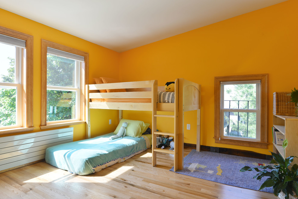 Mid-sized eclectic bedroom in Boston with orange walls and light hardwood floors.