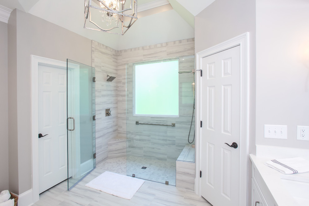 Mid-sized transitional master bathroom in Atlanta with recessed-panel cabinets, white cabinets, an alcove shower, grey walls, porcelain floors, an undermount sink, grey floor, a hinged shower door and white benchtops.