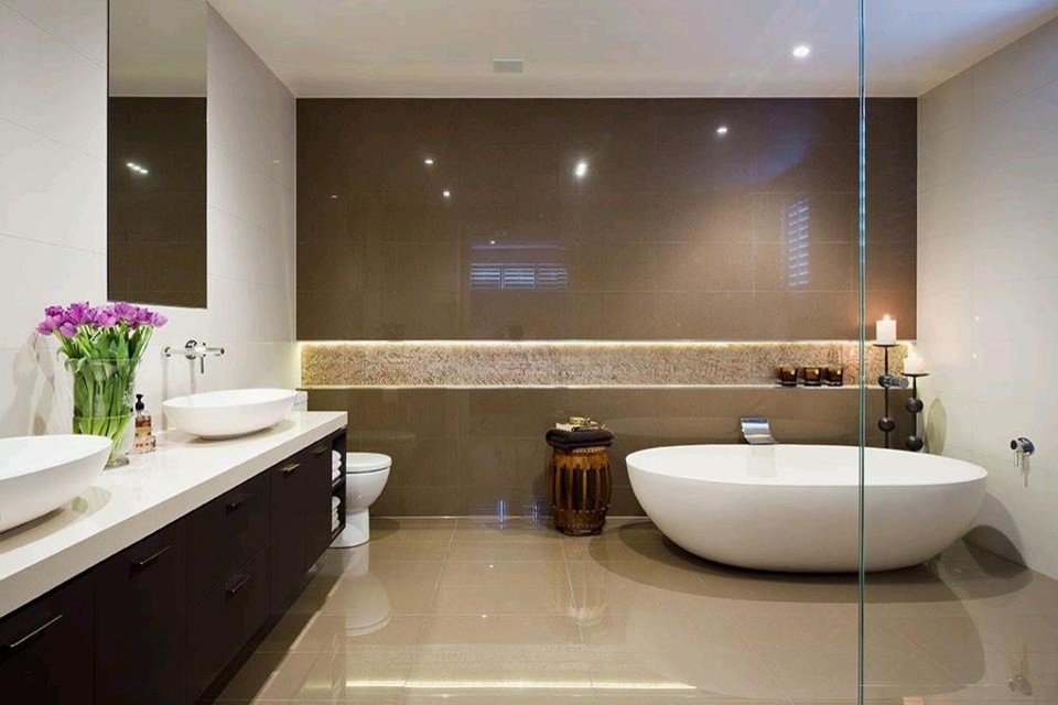 Photo of a contemporary bathroom in Melbourne with brown cabinets, a freestanding tub, an open shower, a one-piece toilet, brown tile, porcelain tile, white walls, porcelain floors, a vessel sink and engineered quartz benchtops.