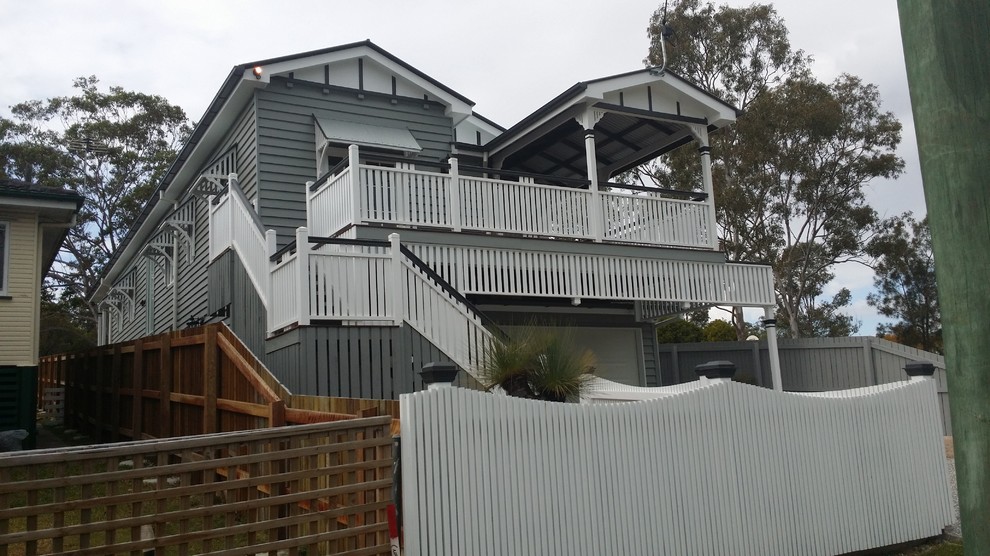 This is an example of a large traditional two-storey grey exterior in Brisbane with wood siding and a gable roof.