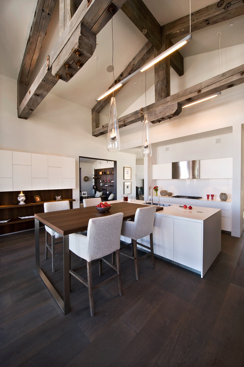 Big and open modern kitchen featuring a wood and metal pub table and four stools