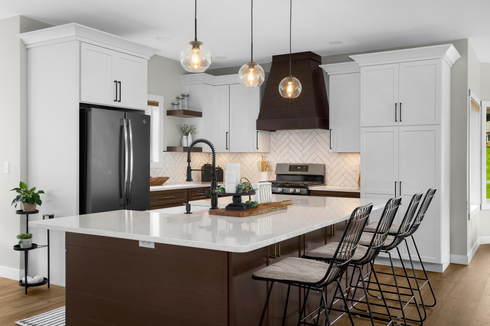 Inspiration for a mid-sized transitional l-shaped vinyl floor and brown floor eat-in kitchen remodel with a farmhouse sink, shaker cabinets, white cabinets, quartz countertops, white backsplash, subway tile backsplash, an island and white countertops