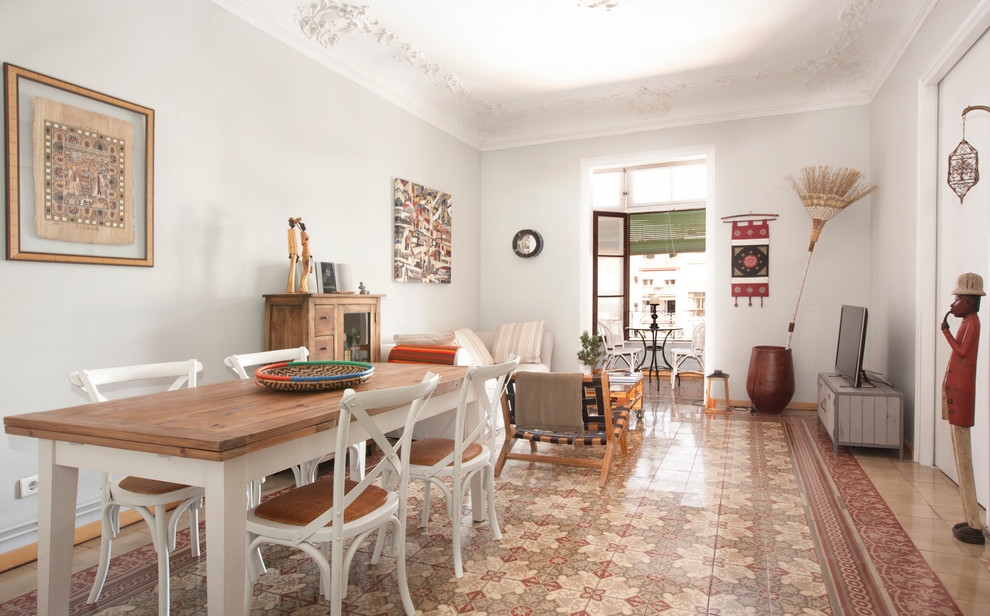 Large tropical open plan dining in Barcelona with white walls, ceramic floors and no fireplace.