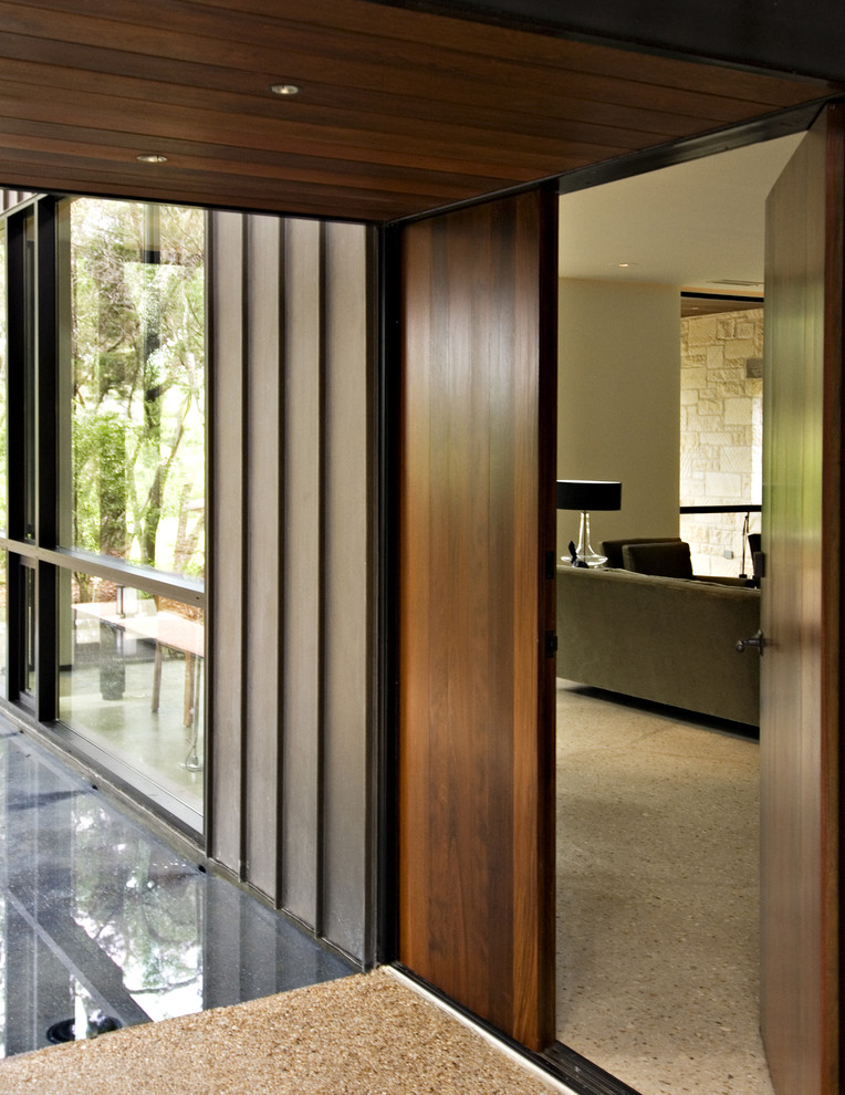 Contemporary entryway in Austin with a single front door and a dark wood front door.