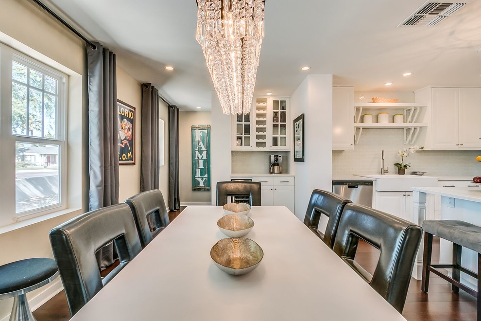 Example of a mid-sized transitional medium tone wood floor and brown floor kitchen/dining room combo design in Phoenix with white walls and no fireplace