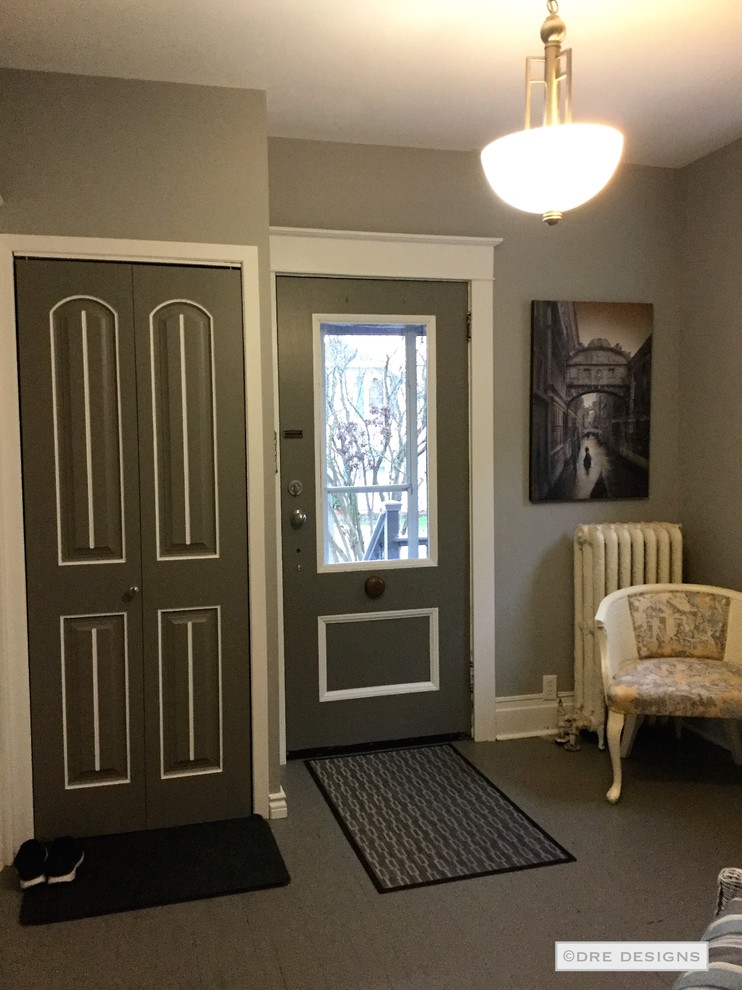 Example of a large transitional painted wood floor foyer design in Toronto with gray walls and a gray front door