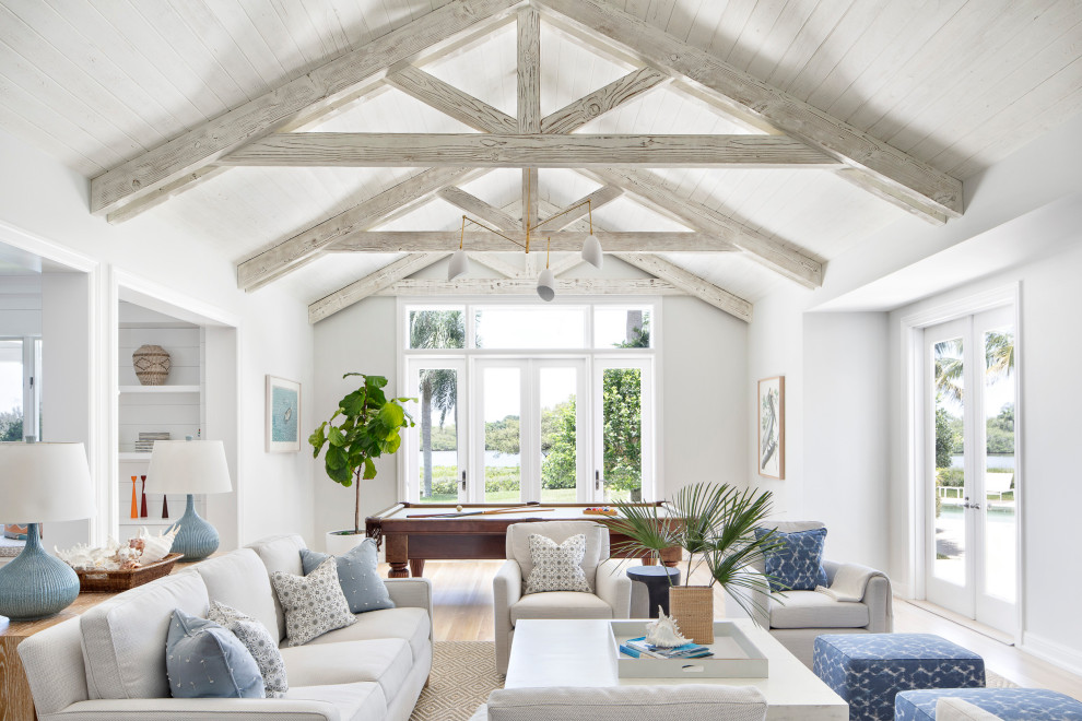 Design ideas for a beach style open concept family room in Other with white walls, light hardwood floors, no fireplace, beige floor, exposed beam, timber and vaulted.
