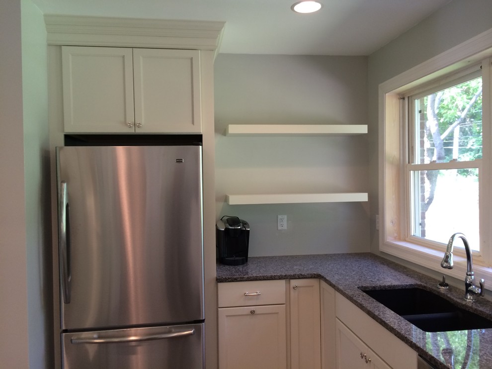 Kitchen - mid-sized transitional galley kitchen idea in St Louis with a double-bowl sink, shaker cabinets, white cabinets, granite countertops, stainless steel appliances and a peninsula
