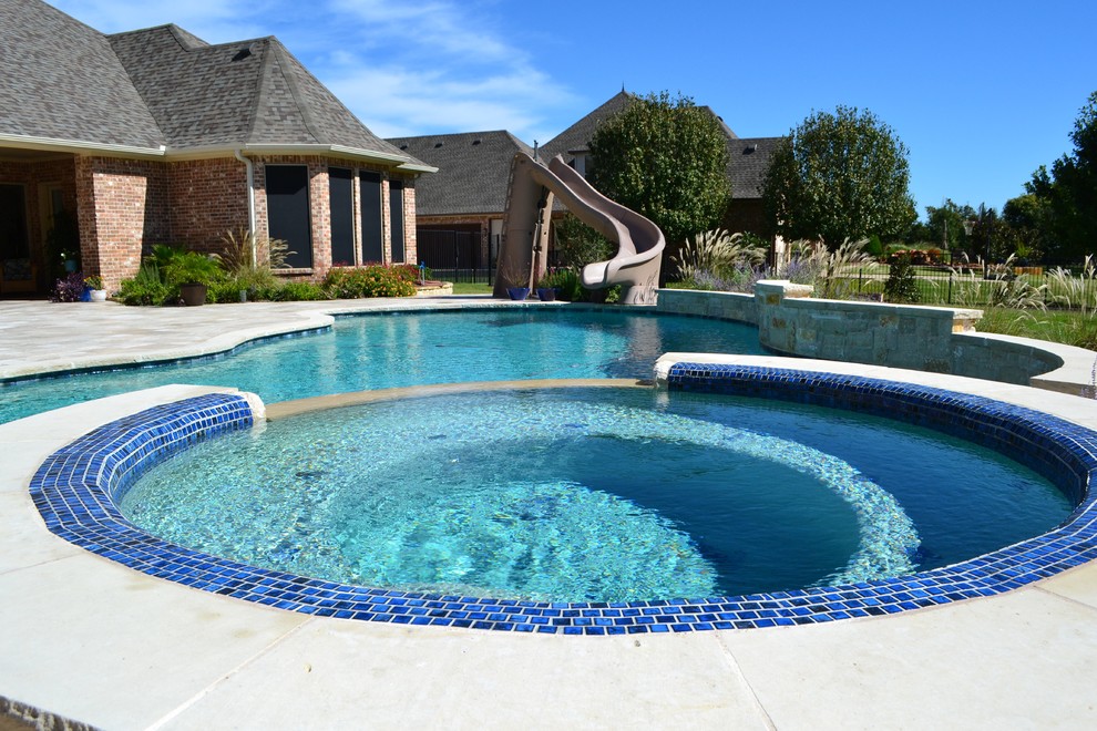 Mid-sized modern backyard round natural pool in Dallas with a hot tub and tile.