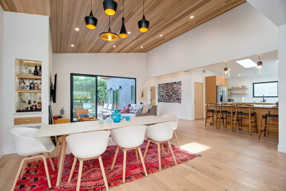 Mid-sized midcentury dining room in Orange County with white walls and light hardwood floors.