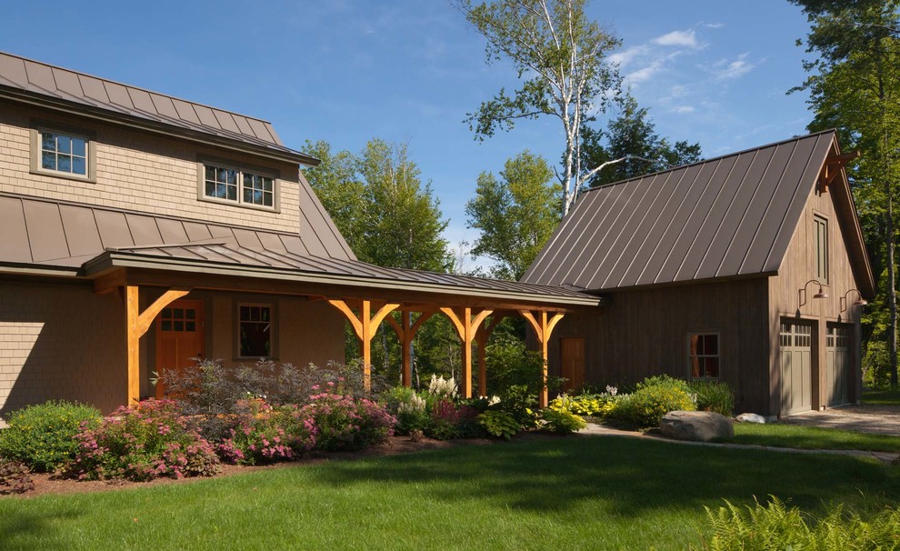 Photo of a traditional two-storey brown exterior in Burlington with a metal roof.