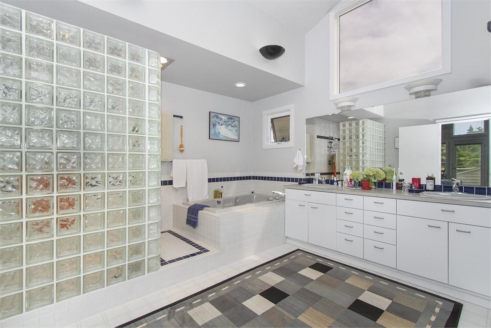 Large contemporary master bathroom in Seattle with a drop-in sink, flat-panel cabinets, white cabinets, concrete benchtops, a hot tub, an open shower, white tile, ceramic tile and linoleum floors.