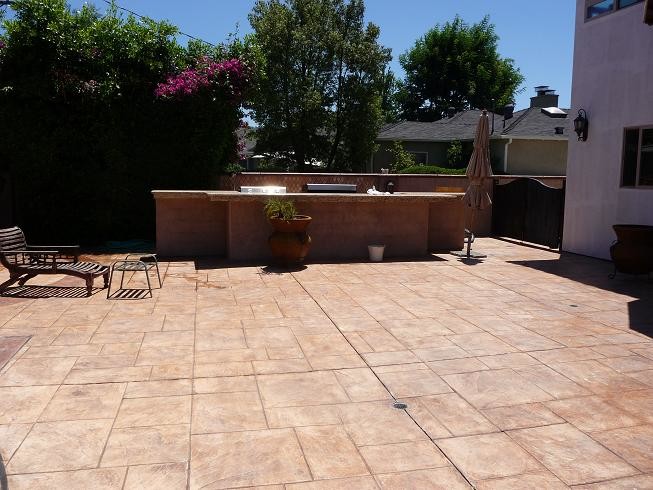 Photo of a large mediterranean backyard patio in Los Angeles with an outdoor kitchen, brick pavers and no cover.
