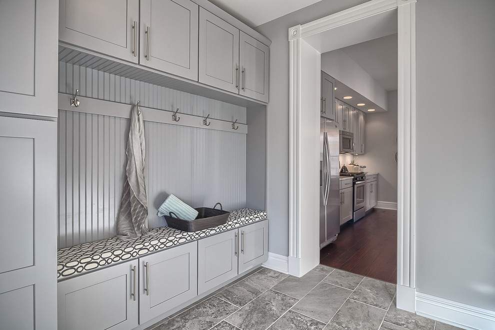 Photo of a mid-sized transitional mudroom in St Louis with grey walls and porcelain floors.
