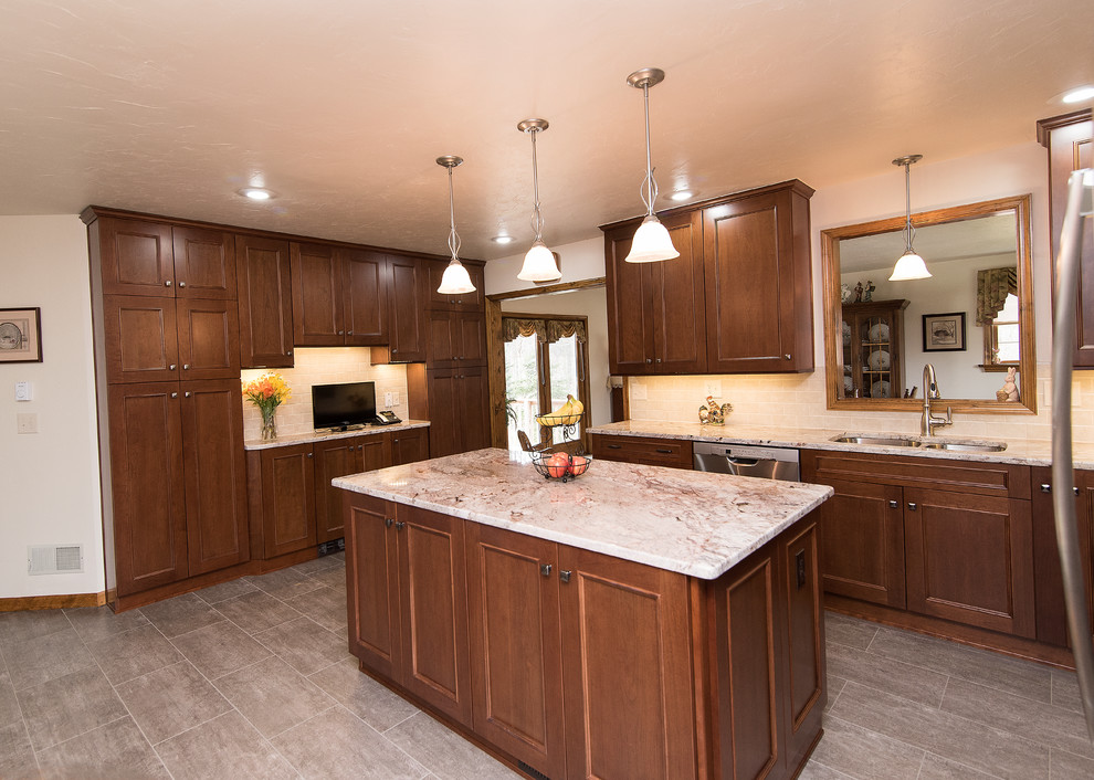 Eat-in kitchen - large traditional l-shaped vinyl floor and beige floor eat-in kitchen idea in Baltimore with an undermount sink, shaker cabinets, medium tone wood cabinets, granite countertops, beige backsplash, ceramic backsplash, stainless steel appliances, an island and white countertops