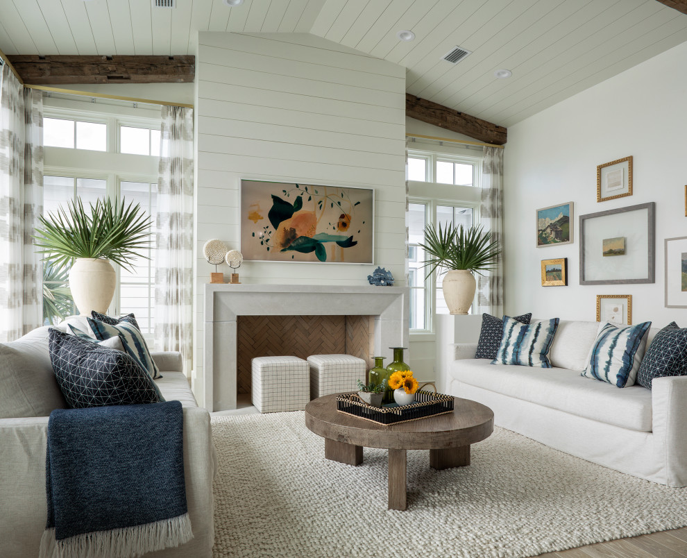 Large beach style open concept painted wood floor, beige floor, exposed beam and shiplap wall living room photo in Other with white walls, a standard fireplace, a shiplap fireplace and a wall-mounted tv