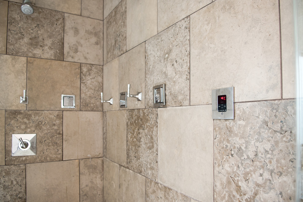 Inspiration for a mid-sized transitional master gray tile and cement tile light wood floor and beige floor drop-in bathtub remodel in Dallas with flat-panel cabinets, gray cabinets, gray walls, a drop-in sink, concrete countertops and a hinged shower door