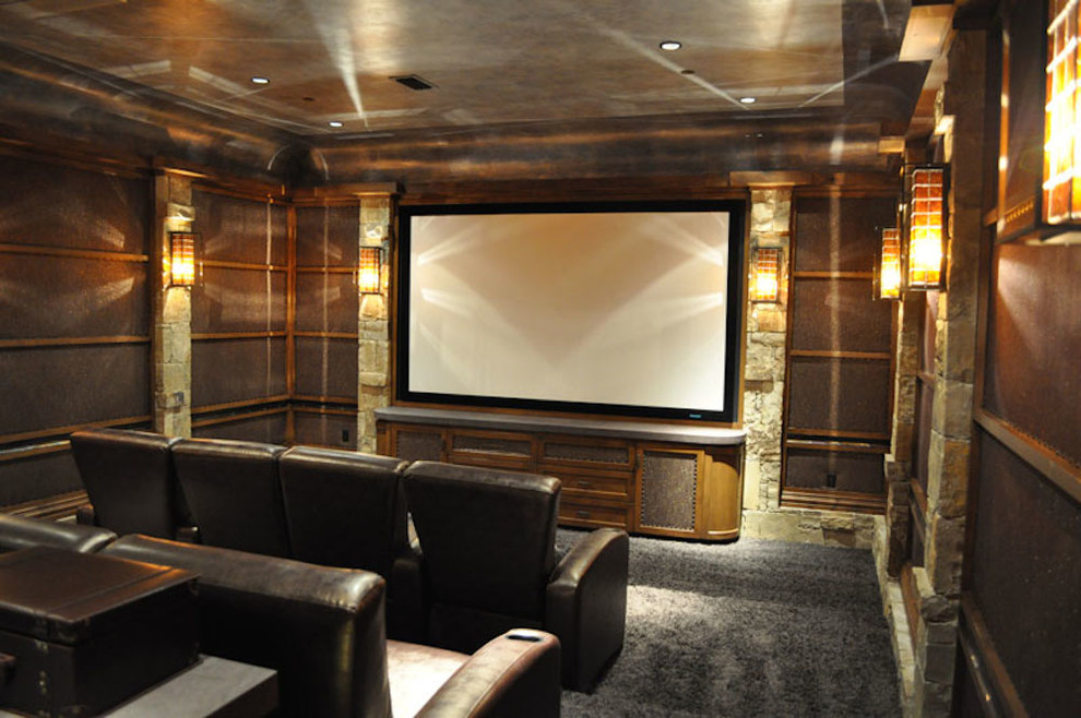 Inspiration for a mid-sized traditional enclosed home theatre in Dallas with carpet, a projector screen, brown walls and grey floor.
