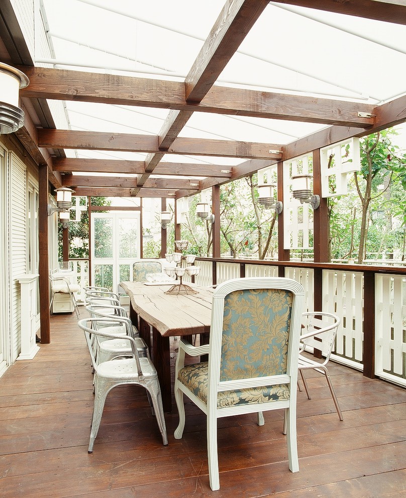 Design ideas for a mid-sized traditional balcony in Other with an awning.