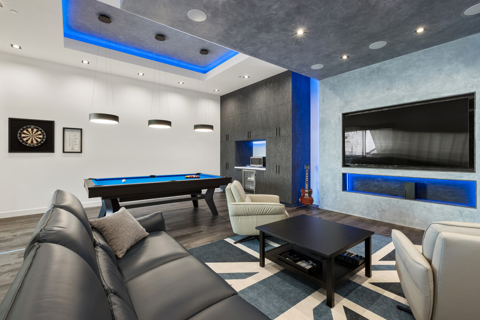 Inspiration for a large contemporary open plan home cinema in Los Angeles with grey walls, dark hardwood flooring, a built-in media unit and grey floors.