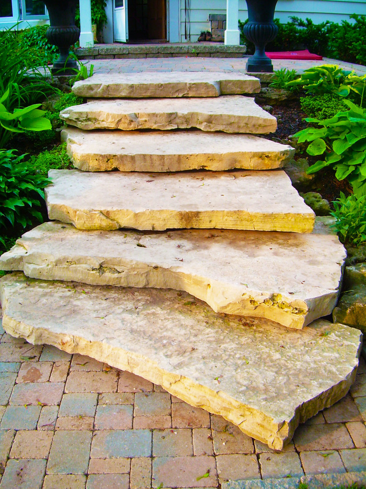 Photo of a small rustic full sun front yard stone driveway in Toronto.