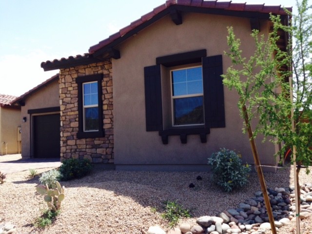 Design ideas for a mid-sized contemporary one-storey beige exterior in Phoenix with stone veneer.