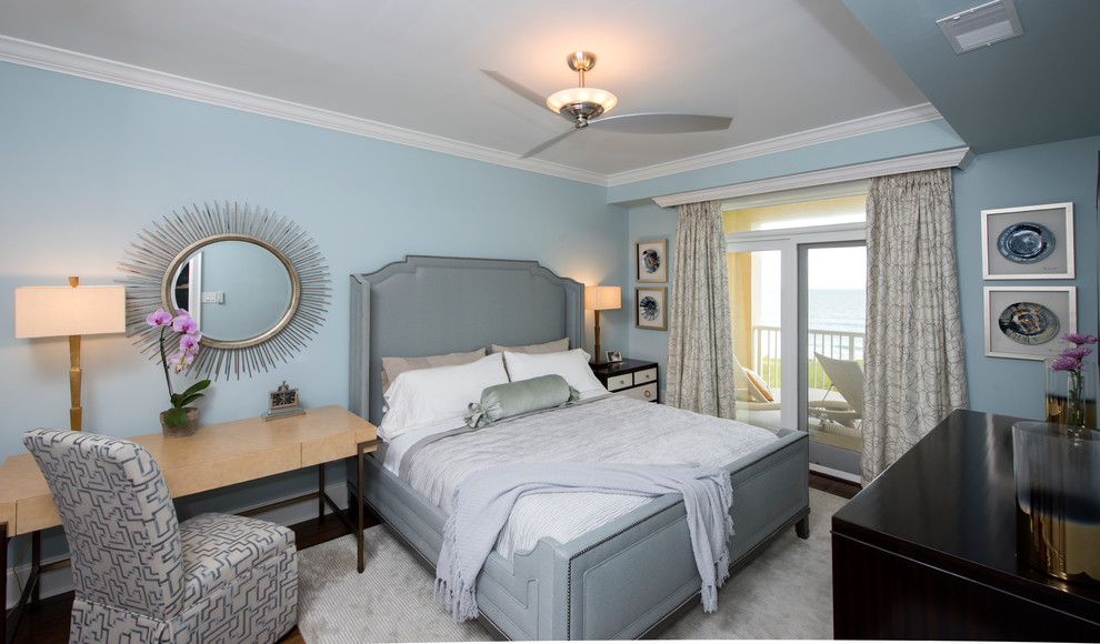 Photo of a mid-sized beach style master bedroom in Other with blue walls and dark hardwood floors.