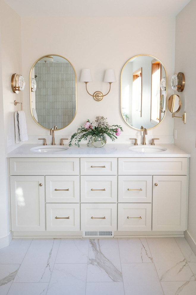 Inspiration for a large transitional master white tile and porcelain tile porcelain tile, white floor and double-sink freestanding bathtub remodel with shaker cabinets, white cabinets, white walls, an undermount sink, quartz countertops, a hinged shower door, white countertops, a niche and a built-in vanity