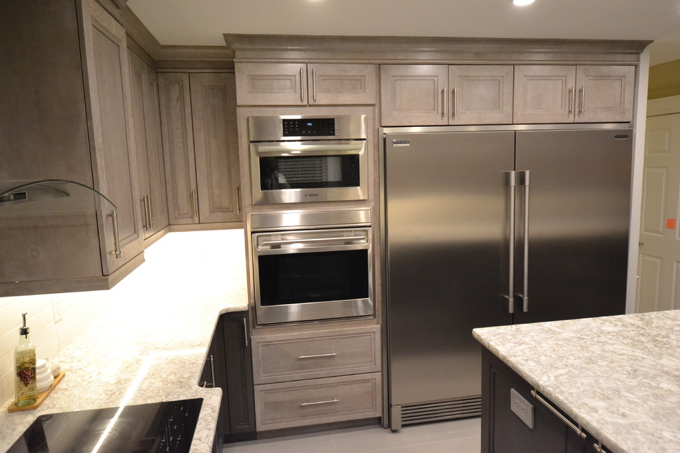 Inspiration for a mid-sized transitional u-shaped eat-in kitchen remodel in Ottawa with recessed-panel cabinets and an island