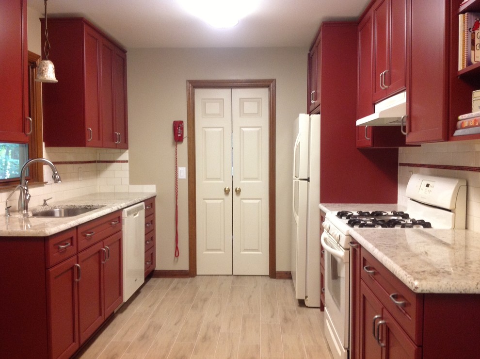 Photo of a mid-sized midcentury galley kitchen pantry in Raleigh with a double-bowl sink, recessed-panel cabinets, red cabinets, granite benchtops, white splashback, glass tile splashback, white appliances, ceramic floors and no island.
