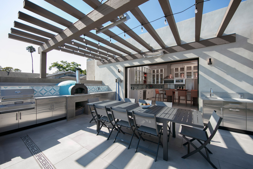 Design ideas for a mid-sized beach style backyard patio in Santa Barbara with an outdoor kitchen, tile and a pergola.