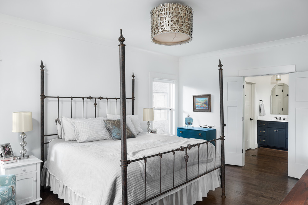 This is an example of a mid-sized arts and crafts master bedroom in Birmingham with white walls, medium hardwood floors, no fireplace and brown floor.