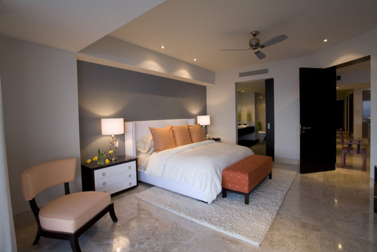Large modern master bedroom in Orange County with grey walls, marble floors, no fireplace and beige floor.