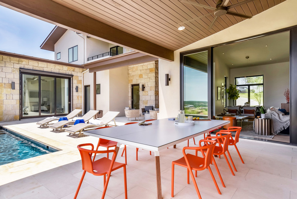 Contemporary backyard verandah in Austin with a roof extension.