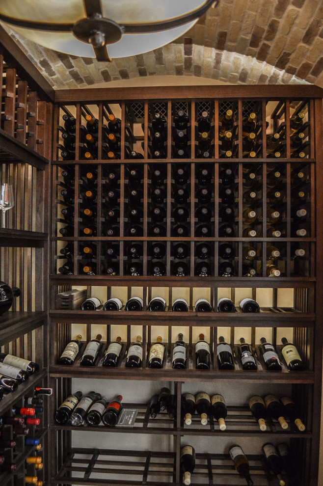 Inspiration for a mid-sized mediterranean wine cellar in San Diego with display racks.